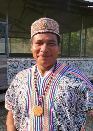 Diomar López Silvano wearing his patterned Shipibo tunic and cap